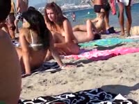 Unsuspecting barely of legal age beauties relax on the beach while voyeur cam records them